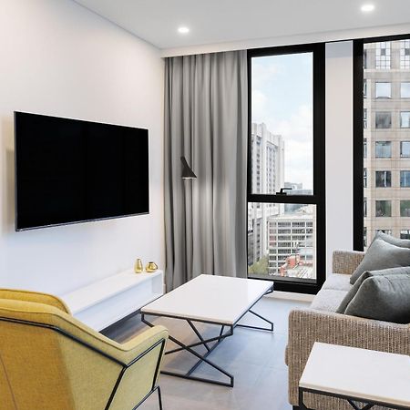 Meriton Suites Melbourne Exterior foto A living room